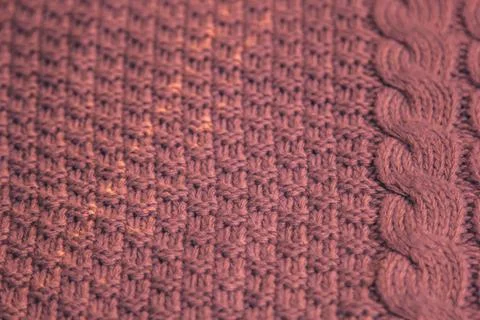Pattern of colorful knitted sweaters closeup. Handmade merino wool product... Stock Photos