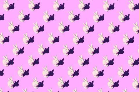 Pattern composition of Easter bunnies on pastel red background. Minimalist Stock Illustration