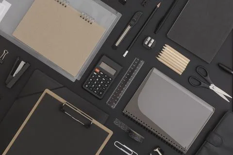 Pattern composition of office and school stationery on black leather backgrou Stock Photos