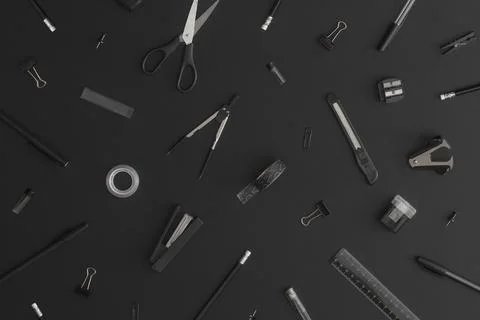 Pattern composition of office and school stationery on black leather backgrou Stock Photos