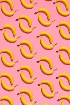 Pattern composition of a pair of bananas lying next to a pink background ,... 写真素材