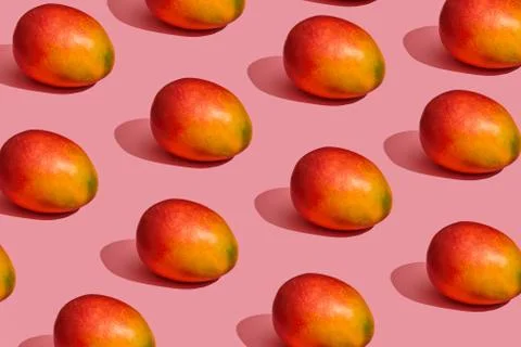 Pattern composition of a sweet tasty mango lying next to a pink background , top 写真素材
