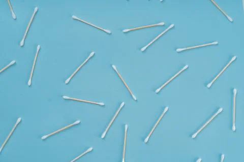 Pattern of cotoon wooden swabs on blue background. Eco friendly concept of zero Stock Photos