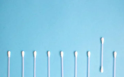 The pattern of the cotton buds on a blue background Stock Photos