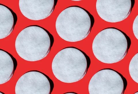 Pattern of cotton pads with hard shadows on a red background Stock Photos