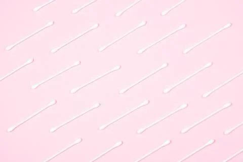 Pattern of cotton swabs on pink background. Stock Photos