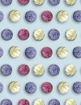 Pattern of cupcakes with cream on light blue background, top view Stock Photos