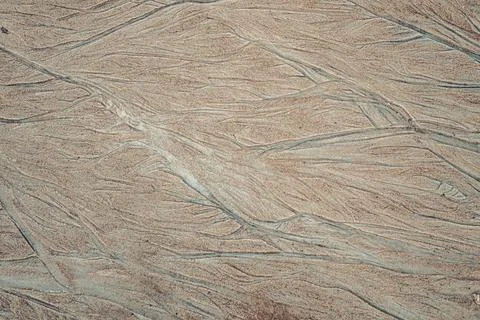 Pattern of curved lines formed in the sand by runoff water Stock Photos