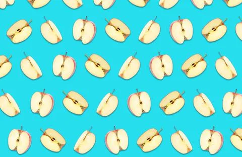 Pattern of cut apples on blue background Stock Photos