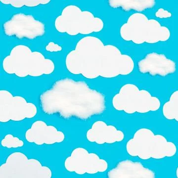 A pattern of cut-out white clouds on a blue background. Foto stock