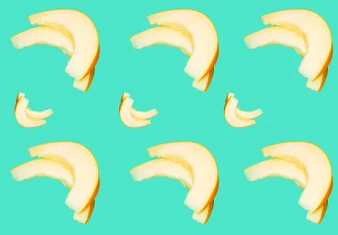 Pattern with cut slices of juicy melon on a blue background. Stock Photos