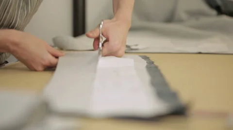 Pattern cutting with a piece of fabric on a table. Stock Footage 51430279