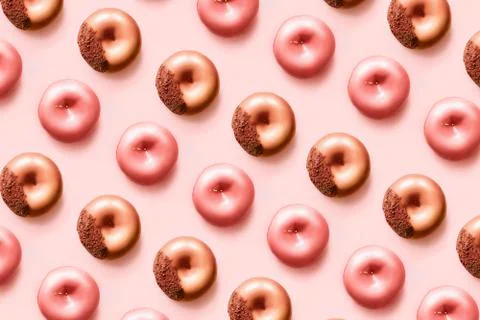Pattern of d onuts with icing and chocolate on pastel pink background.Sweet Stock Photos