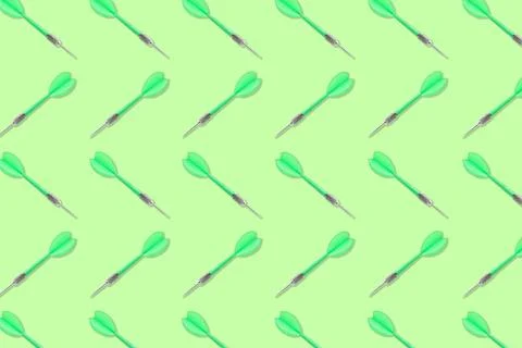 Pattern of darts on light green background Foto stock