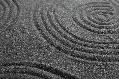 Pattern on decorative black sand, closeup. Zen and harmony Stock Photos