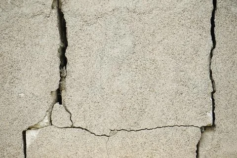 Pattern decorative uneven cracked real stone wall surface with cement, close- Stock Photos