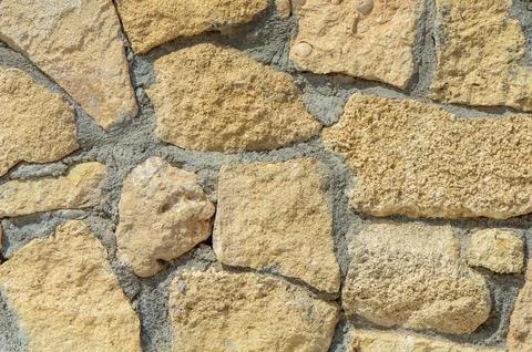 Pattern decorative uneven cracked real stone wall surface with cement. with.. Stock Photos