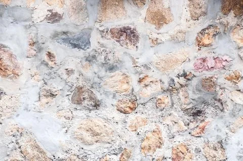 Pattern  decorative uneven cracked real stone wall surface with cement,for .. Stock Photos