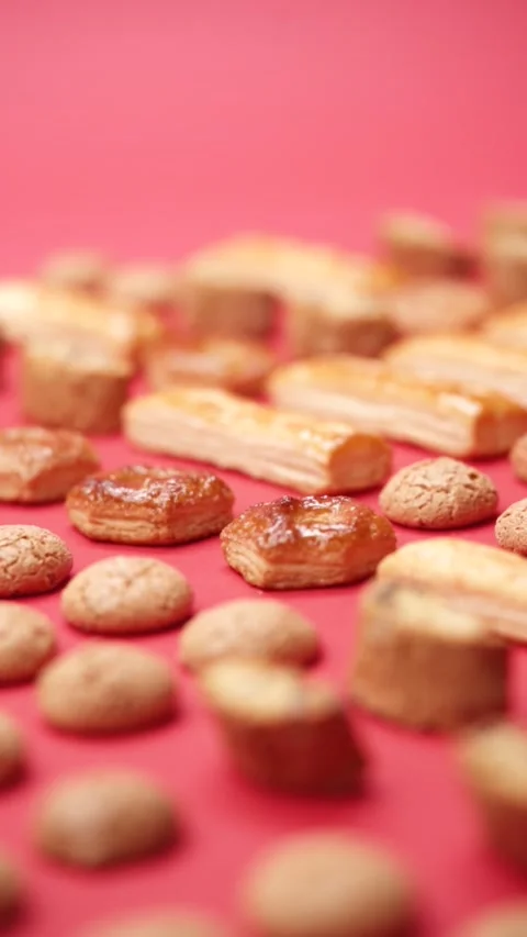A pattern of different cookies laid out on a red background Stock Footage 171738321