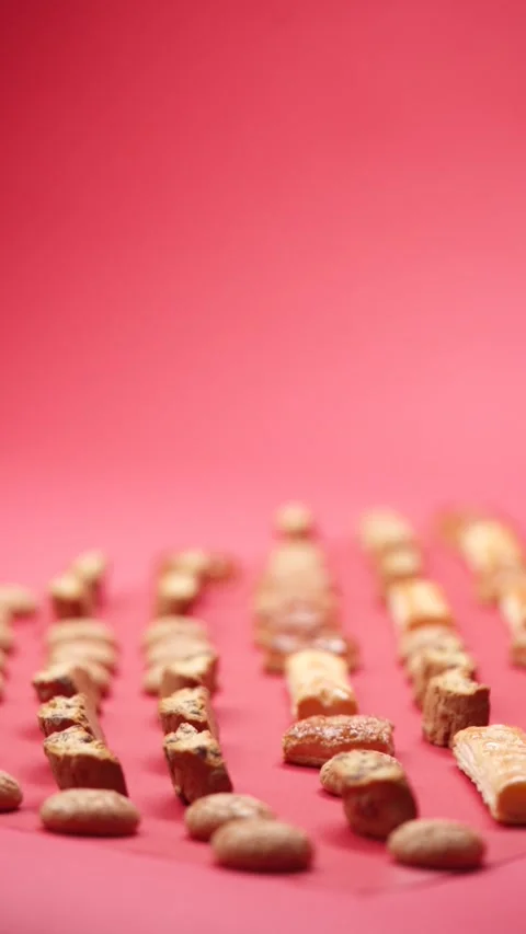A pattern of different cookies laid out on a red background Stock Footage 171738863