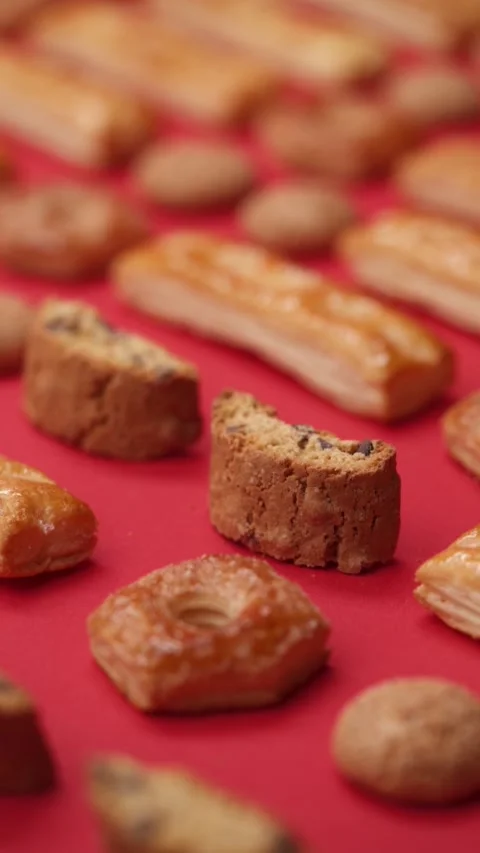 A pattern of different cookies laid out on a red background Stock Footage 171739093