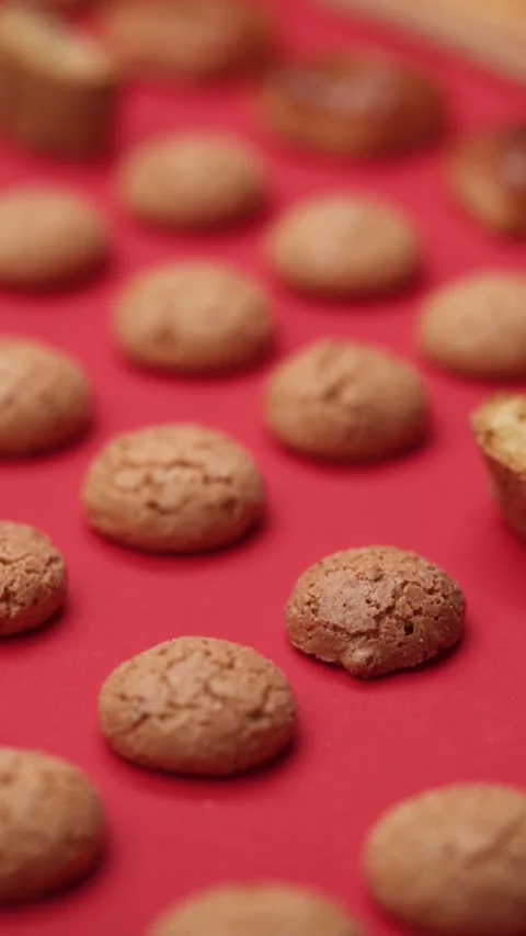 A pattern of different cookies laid out on a red background Stock Footage 171739599