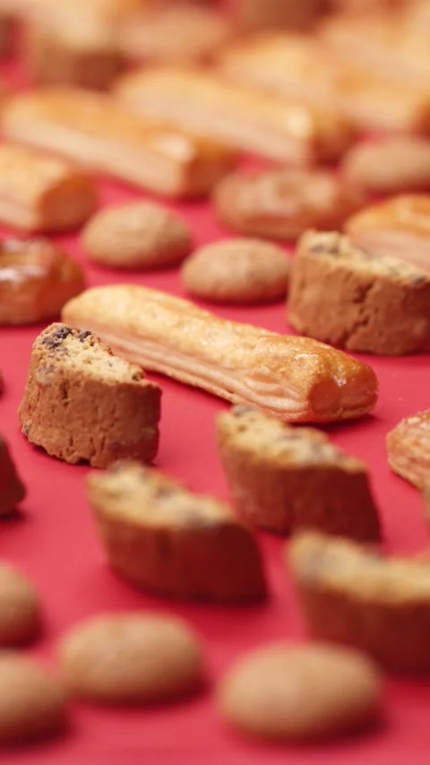 A pattern of different cookies laid out on a red background Stock Footage 171739726