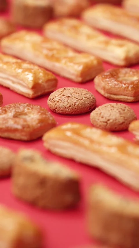 A pattern of different cookies laid out on a red background Stock Footage 171739863