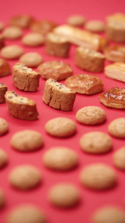 A pattern of different cookies laid out on a red background Stock Footage 171740056