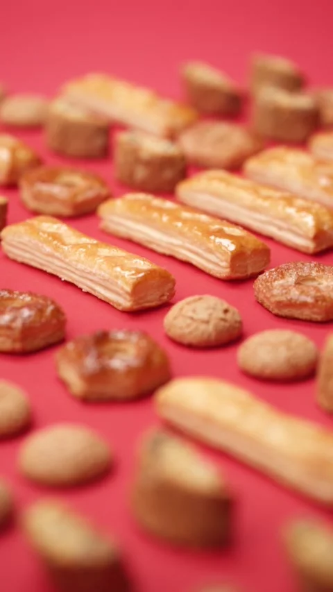 A pattern of different cookies laid out on a red background Stock Footage 171740155