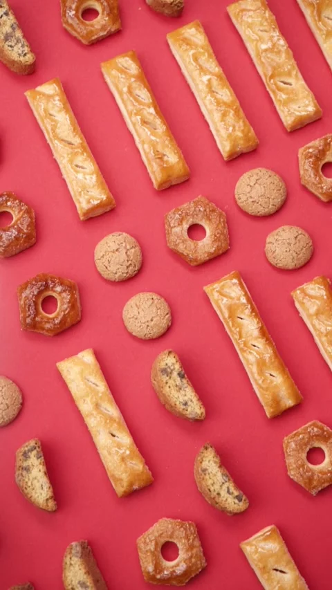 A pattern of different cookies laid out on a red background Stock Footage 171740339