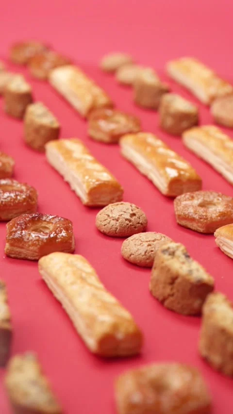 A pattern of different cookies laid out on a red background Stock Footage 171740428