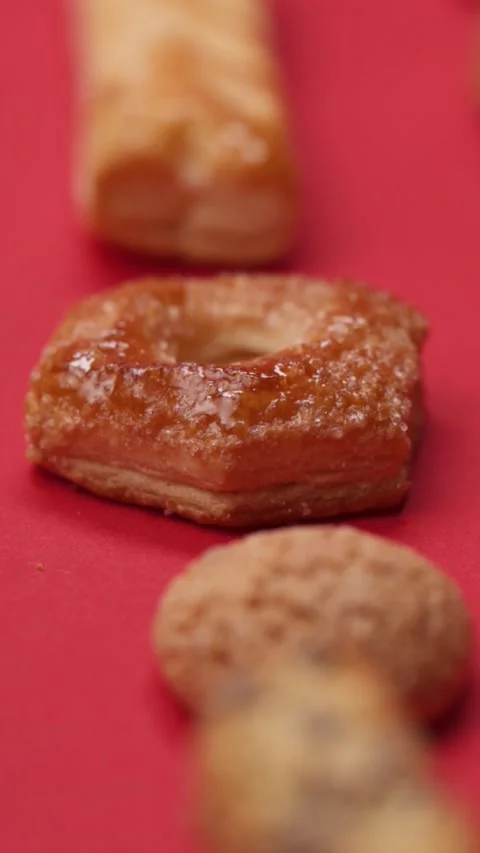 A pattern of different cookies laid out on a red background Stock Footage 171741364