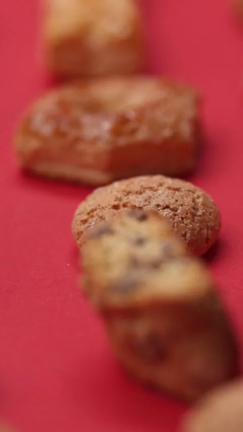 A pattern of different cookies laid out on a red background Stock Footage 171742260