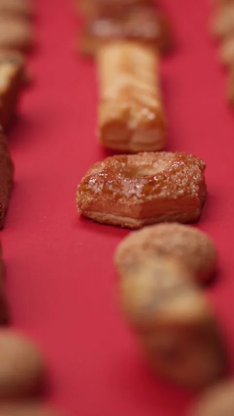 A pattern of different cookies laid out on a red background Stock Footage 171742927