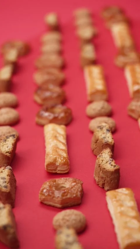 A pattern of different cookies laid out on a red background Stock Footage 171743882