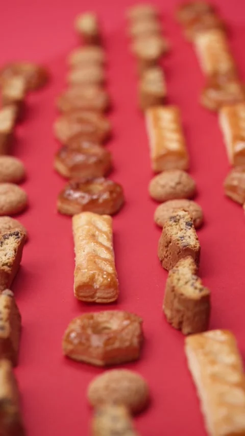 A pattern of different cookies laid out on a red background Stock Footage 171744197