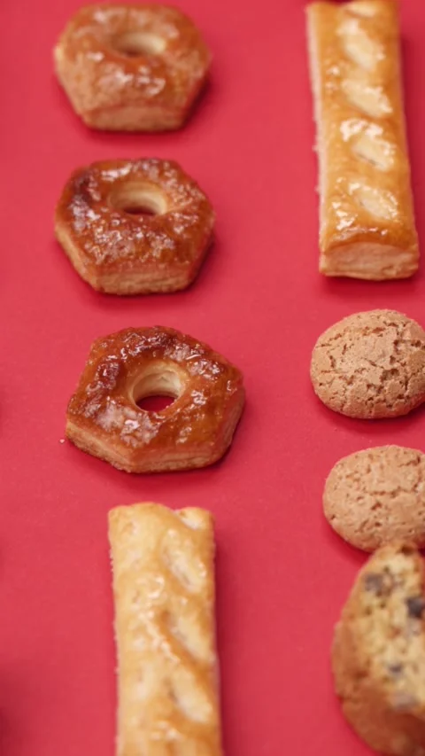 A pattern of different cookies laid out on a red background Stock Footage 171745347