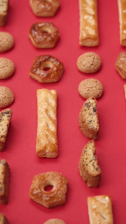 A pattern of different cookies laid out on a red background Stock Footage 171745412