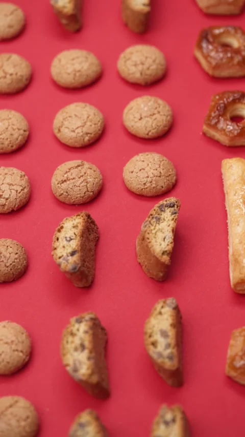 A pattern of different cookies laid out on a red background Stock Footage 171746705
