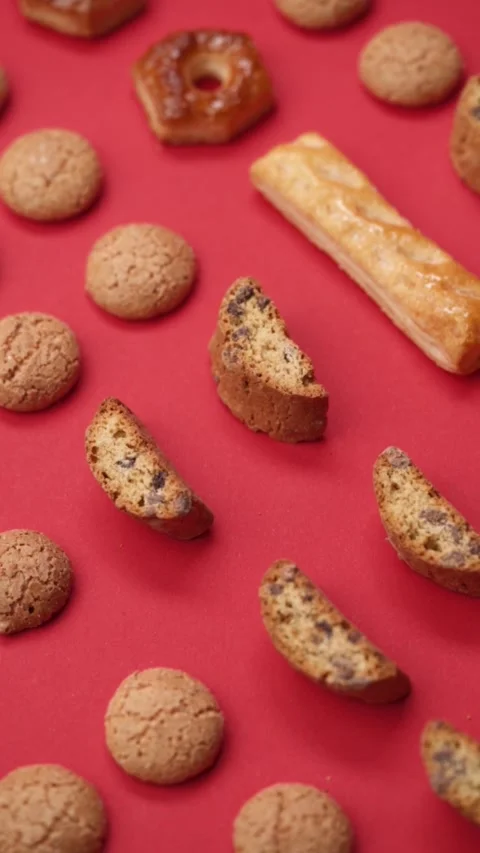 A pattern of different cookies laid out on a red background Stock Footage 171747584
