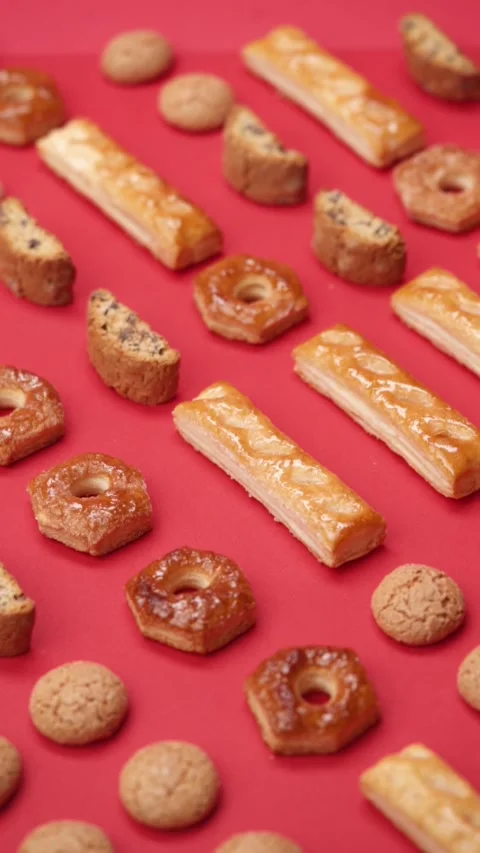 A pattern of different cookies laid out on a red background Stock Footage 171747748