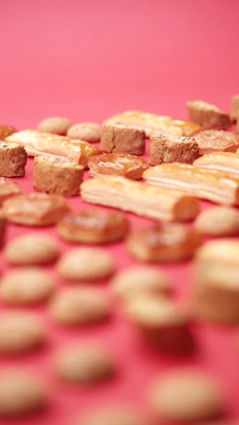 A pattern of different cookies laid out on a red background Stock Footage 171747819