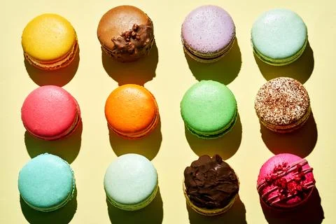 Pattern of different macarons with various flavors. Bright colours. French .. Stock Photos