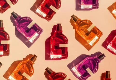 Pattern of different perfume bottles on a pastel beige background in the Stock Photos