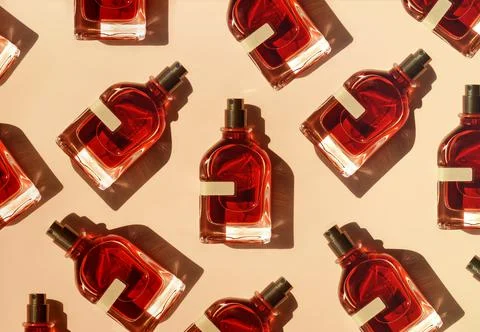 Pattern of different perfume bottles on a pastel beige background in the Stock Photos
