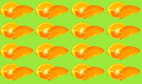 A pattern of different pieces of orange fruit on a green background. Fotos Stock