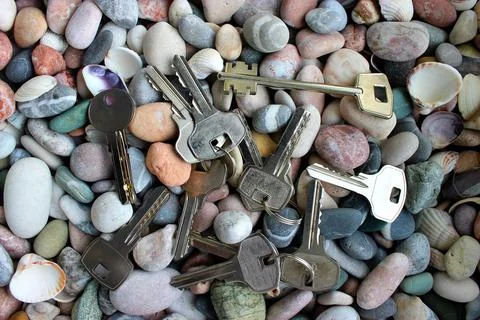 A pattern of different types of keys from locks laid out on stones top view Foto stock