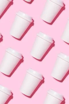 Pattern of disposable coffee cups on a pink background. Stock Photos