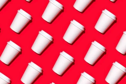 Pattern of disposable coffee cups on a red background. Stock Photos
